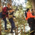 A family enjoys a thrilling day on a ropes course in Cercedilla, Spain.