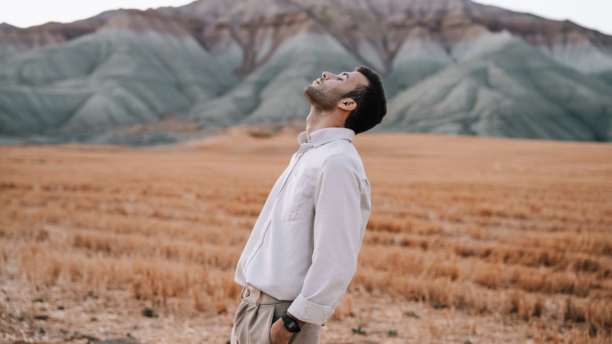 Man in white shirt enjoying tranquility in a scenic field in Nallıhan, Ankara, Türkiye.